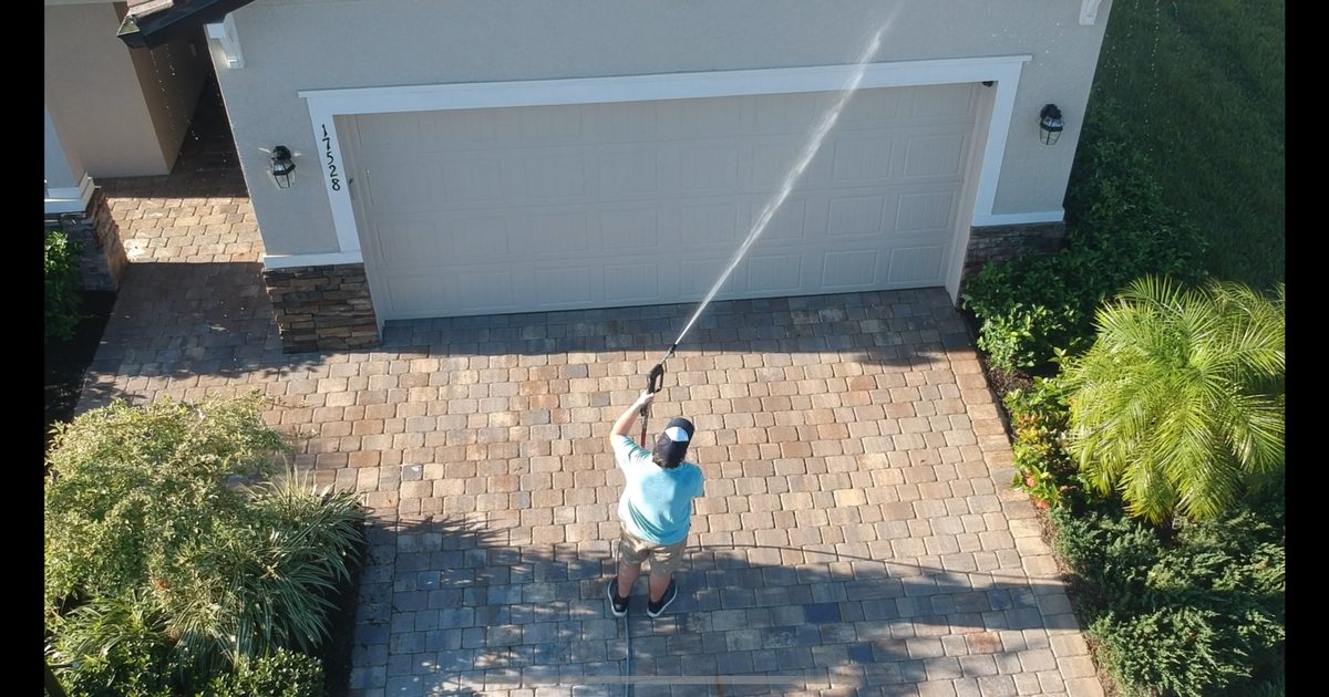 Brilliant white concrete driveway after professional pressure washing in Bradenton, FL